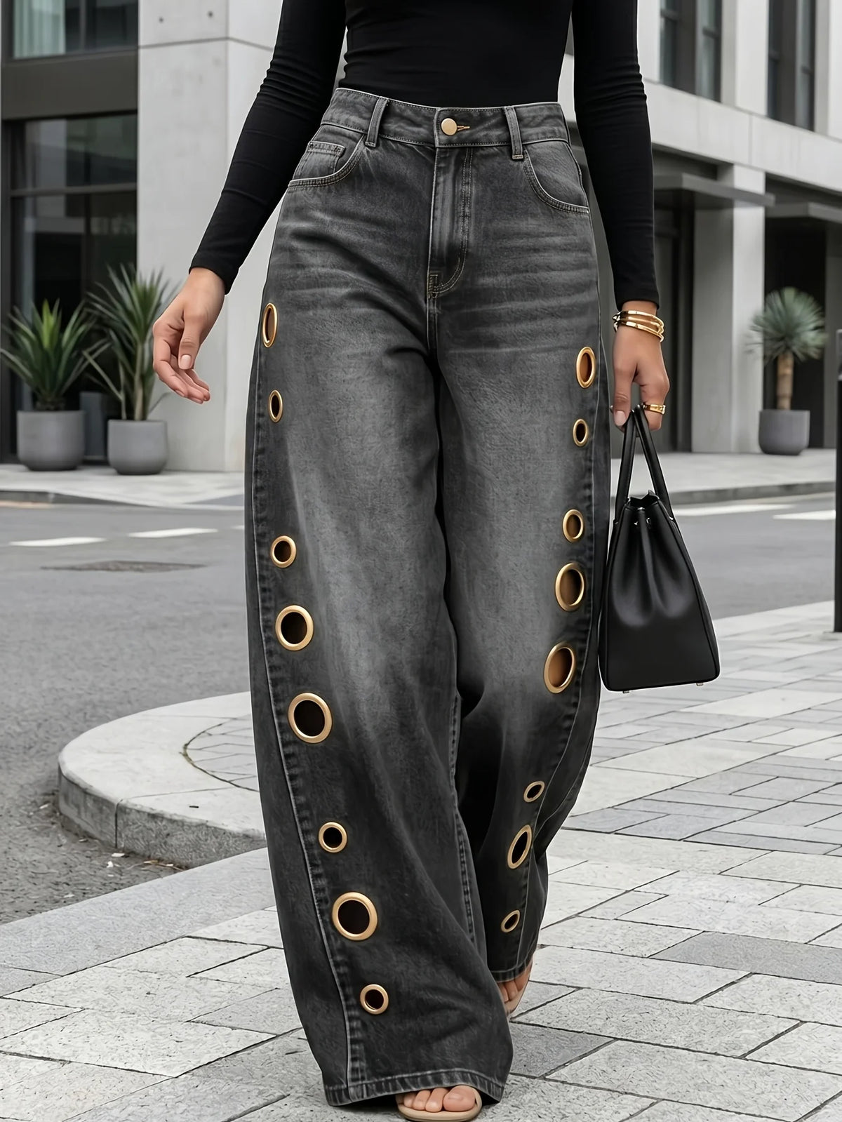 Retro-style wide-leg jeans with metallic eyelets, high-waisted, loose, floor-length fit, gradient eyelets of varying sizes on both sides, distressed washed finish, classic front and back pockets, perfect for everyday casual w